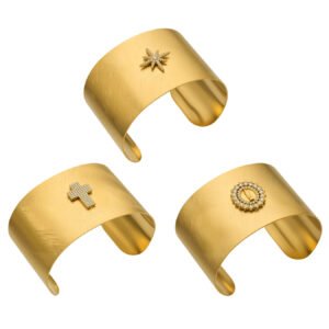 Wide brushed 18K gold plated open cuff bangles featuring pavé cubic zirconia north star, cross, and Virgin Mary halo emblems in 316L stainless steel