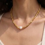 Gold and silver plated chunky irregular pebble bead strand necklace with a center pearl in ore material metal