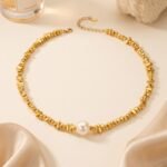 Gold and silver plated chunky irregular pebble bead strand necklace with a center pearl in ore material metal