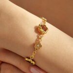 Gold plated stainless steel jewelry set featuring alternating crystal pave flowers and faceted glass five-petal flower motifs