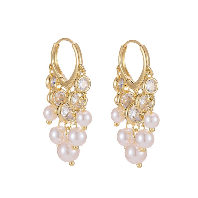 Pearl tassel hoop earrings wholesale featuring V-shaped huggie latch hoop with bezel-set cubic zirconia crystals and cascading cluster of round shell pearls on 18k gold and palladium plated copper.
