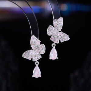 Pastel butterfly crystal earrings wholesale featuring pave cubic zirconia butterfly posts with dangling ice blue and soft pink teardrop crystal drops on palladium plated copper base.