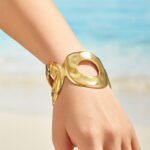 Wide hammered gold and silver plated open cuff bangle with organic oval cutout in 316L stainless steel