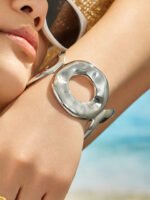Wide hammered gold and silver plated open cuff bangle with organic oval cutout in 316L stainless steel