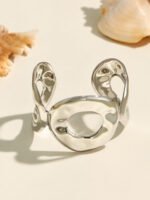 Wide hammered gold and silver plated open cuff bangle with organic oval cutout in 316L stainless steel