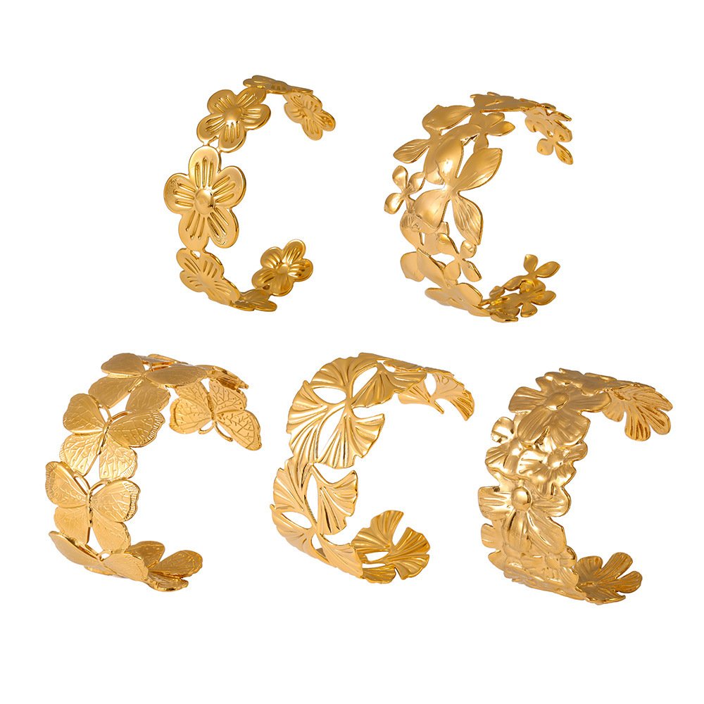 Gold and silver 316L stainless steel open cuff bangles featuring sculpted 3D floral, daisy, and detailed butterfly motifs