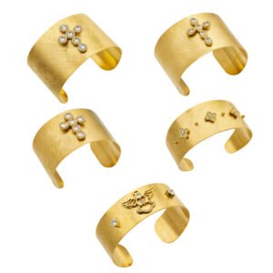 Wide brushed 18K gold plated open cuff bangles adorned with pavé cubic zirconia cross, angel, and clover motifs in 316L stainless steel