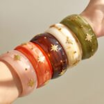 Gold plated starburst inlaid wide resin bangle bracelet in 316L stainless steel