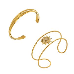 Gold and silver double-wire open cuff bangles featuring a pavé cubic zirconia sunburst centerpiece and a triple-strand interwoven gold band