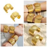Wide brushed 18K gold plated open cuff bangles featuring dramatic 3D smooth and hammered sunburst emblems in 316L stainless steel