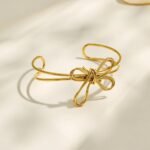 Gold and silver multi-strand wire bow knot open cuff bangle bracelet in polished 316L stainless steel