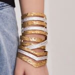 Two tone 18K gold plated and enamel white silver stainless steel open cuff bangles featuring leaf, wave, and multi-band hammered textures