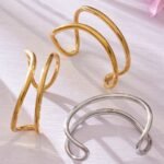 Minimalist double-wire wave open cuff bangle in 18K gold and silver plated 316L stainless steel with a fluid organic design