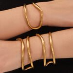Minimalist double-wire wave open cuff bangle in 18K gold and silver plated 316L stainless steel with a fluid organic design