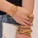 Minimalist double-wire wave open cuff bangle in 18K gold and silver plated 316L stainless steel with a fluid organic design