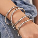 Minimalist double-wire wave open cuff bangle in 18K gold and silver plated 316L stainless steel with a fluid organic design
